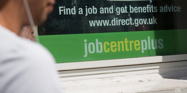 A pedestrian walks past a job centre in London, U.K., on Tuesday, Aug. 6, 2013. Bank of England governor Mark Carney will present a review tomorrow on implementing forward guidance in the U.K. as improving economic data boosts the future cost of money. Photographer: Simon Dawson/Bloomberg via Getty Images