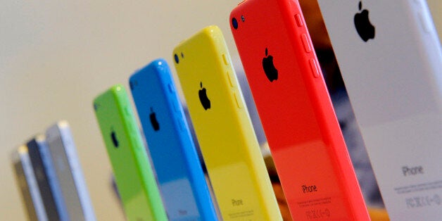 The new Apple Inc. iPhone 5C sit on display during a product announcement in Cupertino, California, U.S., on Tuesday, Sept. 10, 2013. Apple Inc. announced two new iPhones including one with lower prices and more color options, in a strategy shift by Cook to reach a broader range of customers around the world. Photographer: David Paul Morris/Bloomberg via Getty Images