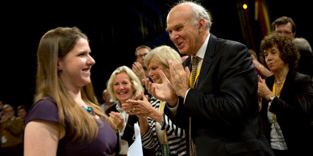 British Business Secretary Vince Cable (R) applauds as Jo Swinson (L), Parliamentary Under-Secretary of State for Employment Relations and Consumer Affairs, leaves the stage after speaking at the Liberal Democrat Party Conference in Brighton on September 26, 2012. The Liberal Democrats' conference in Brighton is seeking to reinvigorate a party bruised by rock-bottom approval ratings after a series of concessions to senior coalition partners the Conservatives. AFP PHOTO / ADRIAN DENNIS (Photo credit should read ADRIAN DENNIS/AFP/GettyImages)