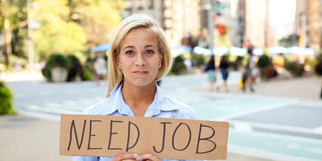 A woman holding a sign saying 'need job'