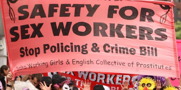 A masked parade of sex workers and supporters, take part in a parade, in Soho, London in an event to thank residents for helping to keep sex workers safe.