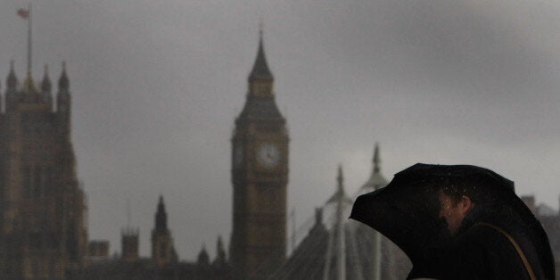 LONDON - MARCH 10: A man holds onto his umbrella as he braves wind and rain on Waterloo Bridge on March 10, 2008 in London, England. Commuters battled rain and winds of up to 60 miles per hour on their way to work. (Photo by Daniel Berehulak/Getty Images)