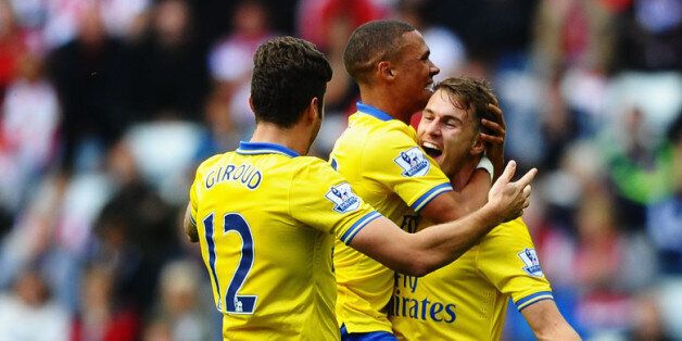 SUNDERLAND, ENGLAND - SEPTEMBER 14: Aaron Ramsey (R) of Arsenal celebrates his goal with team mates Kieran Gibbs and Olivier Giroud during the Barclays Premier League match between Sunderland and Arsenal at the Stadium of Light on September 14, 2013 in Sunderland, England. (Photo by Laurence Griffiths/Getty Images)