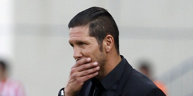 Atletico Madrid's Argentinian coach Diego Simeone reacts during the Spanish league football match Club Atletico de Madrid vs Malaga CF at the Vicente Calderon stadium in Madrid on May 11, 2014. AFP PHOTO/ ALBERTO DI LOLLI (Photo credit should read ALBERTO DI LOLLI/AFP/Getty Images)