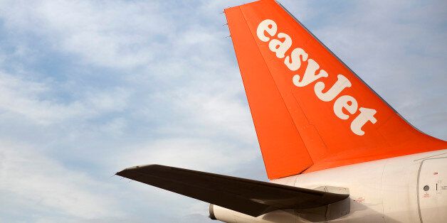 A logo sits on the tailfin of an Airbus A319 aircraft, operated by EasyJet Plc, at the airline's hub at London Luton Airport in Luton, U.K., on Tuesday, Nov. 26, 2013. Shares in International Consolidated Airlines Group SA (IAG) and EasyJet Plc climbed at least 2 percent, pushing a gauge of travel and leisure companies higher, as oil prices slid in reaction to Iran's nuclear deal with world powers. Photographer: Simon Dawson/Bloomberg via Getty Images