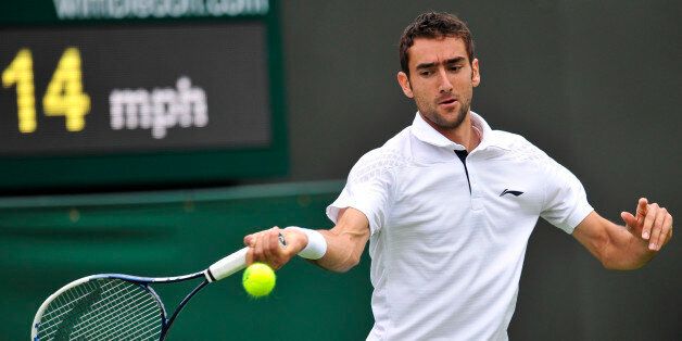 Croatia's Marin Cilic returns against Cyprus's Marcos Baghdatis on his way to victory in their men's first round match on day one of the 2013 Wimbledon Championships tennis tournament at the All England Club in Wimbledon, southwest London, on June 24, 2013. Cilic won 6-3, 6-4, 6-4. AFP PHOTO / GLYN KIRK - RESTRICTED TO EDITORIAL USE (Photo credit should read GLYN KIRK/AFP/Getty Images)
