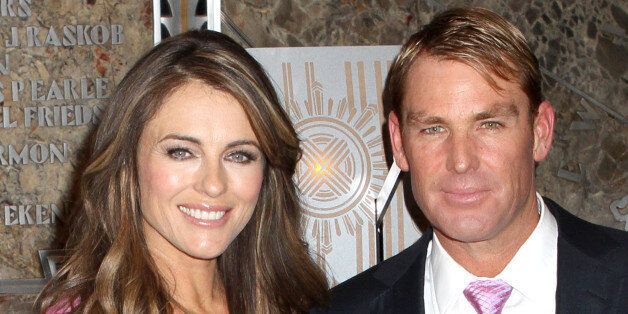 MELBOURNE, AUSTRALIA - JANUARY 13: Shane Warne (L) and Elizabeth Hurley arrive at Crown's IMG Tennis Player's Party at Crown Towers on January 13, 2013 in Melbourne, Australia. (Photo by Graham Denholm/Getty Images)