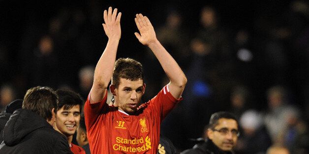 Flanagan applauds the away supporters following Liverpool's win at Fulham