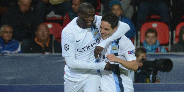Manchester City's Ivorian midfielder Yaya Toure (L) celebrates with his teammate French midfielder Samir Nasri after he scored during the UEFA Champions League Group D football match FC Viktoria Plzen vs Manchester City in Plzen on September 17, 2013. AFP PHOTO / MICHAL CIZEK (Photo credit should read MICHAL CIZEK/AFP/Getty Images)