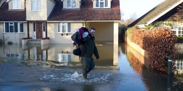 Residents walk through flooding in Wraysbury, Berkshire.