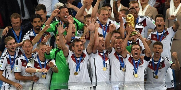 Germany's forward Mario Goetze (R) celebrates with teammates after scoring during the final football match between Germany and Argentina for the FIFA World Cup at The Maracana Stadium in Rio de Janeiro on July 13, 2014. AFP PHOTO / JUAN MABROMATA (Photo credit should read JUAN MABROMATA/AFP/Getty Images)