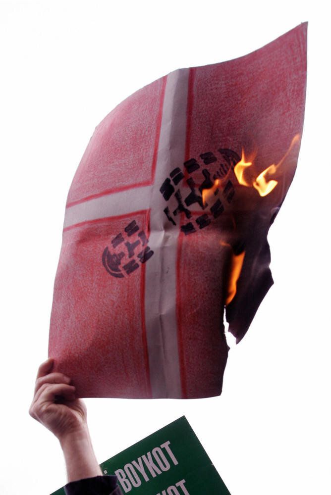An Islamist protestor burns a cardboard