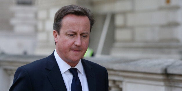 LONDON, ENGLAND - OCTOBER 23: British Prime Minster David Cameron makes his way to Downing Street from the Houses of Parliament on October 23, 2013 in London, England. David Cameron announced in his weekly Prime Minister's Questions in the House of Commons that 'green' energy taxes are to be reviewed after suggesting they pushed up household bills to unacceptable levels. (Photo by Oli Scarff/Getty Images)