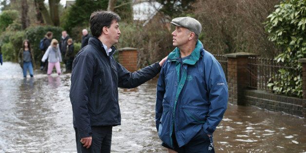 WRAYSBURY, ENGLAND - FEBRUARY 11: Labour party leader Ed Miliband (L) talks with resident Peter Horner standing in floodwater on February 11, 2014 in Wraysbury, England. The Environment Agency has issued severe flood warnings for a number of areas on the river Thames west of London. Thousands of homes are under threat and may have been evacuated. (Photo by Peter Macdiarmid/Getty Images)