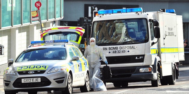 A Royal Navy bomb disposal unit works at the scene where a suspect package was delivered at an Army recruitment office in Brighton, southern England on February 13, 2014. British counter-terrorism police said Thursday they were dealing with a series of suspect packages sent to a string of armed forces recruitment offices. Bomb disposal units have been called to deal with the packages, sent to at least six offices in southeast England, with police sources saying there was a 'low-level' but 'viable' threat. Packages have been sent to offices in Aldershot, Chatham, Brighton, Oxford, Reading, Slough. AFP PHOTO / GLYN KIRK (Photo credit should read GLYN KIRK/AFP/Getty Images)