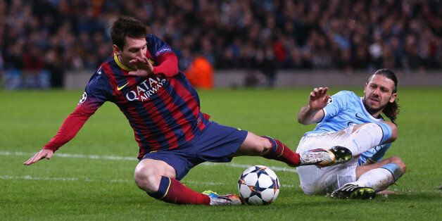 MANCHESTER, ENGLAND - FEBRUARY 18: Martin Demichelis of Manchester City fouls Lionel Messi of Barcelona to concede a penalty and is subsequently sent off during the UEFA Champions League Round of 16 first leg match between Manchester City and Barcelona at the Etihad Stadium on February 18, 2014 in Manchester, England. (Photo by Clive Brunskill/Getty Images)