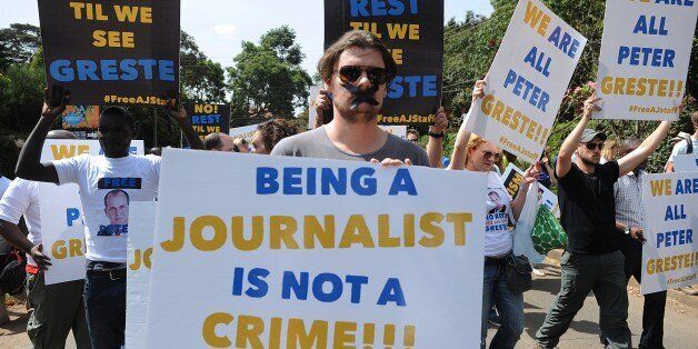 Foreign journalists hold banners as they march to the Egyptian Embassy to show support to Peter Greste, an Australian journalist who was arrested and detained in Cairo while on assignment for Qatar-based Al-Jazeera network, on December 29, 2013, in Nairobi, on February 4, 2014. Greste and two others journalists are accused of spreading lies harmful to state security and joining a terrorist organisation.AFP PHOTO/SIMON MAINA (Photo credit should read SIMON MAINA/AFP/Getty Images)