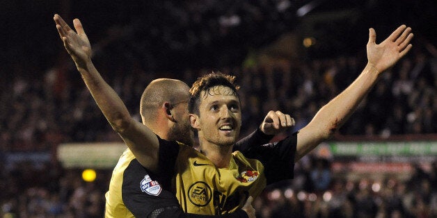 David Mooney celebrates his opener at Griffin Park