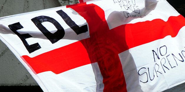 A man holds a flag during a EDL march at Centenary Square in Birmingham.