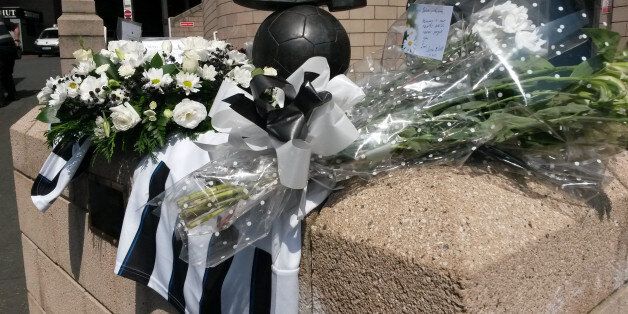 Flowers and football shirts around the Sir Bobby Robson statue outside Newcastle football ground after two fans died on board flight MH17 which was shot down over the Ukraine.