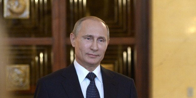 Russia's President Vladimir Putin smiles while speaking with journalists in Itamaraty Palace in Brazilia, early on July 17, 2014. The United States and Europe strengthened sanctions on Moscow over Ukraine yesterday, with President Barack Obama taking his first direct swipes in the finance, military and energy sectors of the Russian economy. Putin warned the biting sanctions will boomerang and hit back at US national interests, will inflicting 'very serious damage' on an already tattered US-Russia relationship. AFP PHOTO / RIA-NOVOSTI / POOL / ALEXEI NIKOLSKY (Photo credit should read ALEXEI NIKOLSKY/AFP/Getty Images)