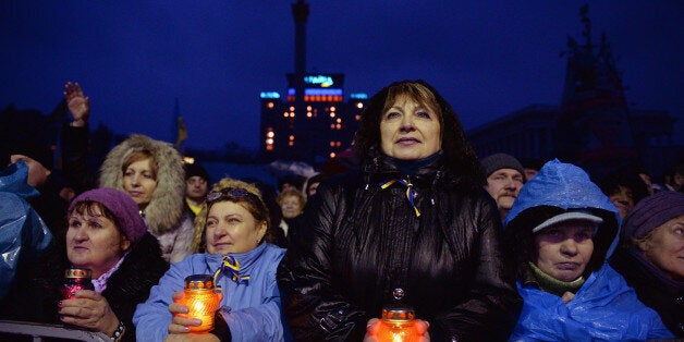 KIEV, UKRAINE - FEBRUARY 22: People react Independence square following the announcement that Ukrainian MPs voted to oust President Viktor Yanukovych on February 22, 2014 in Kiev, Ukraine. Ukrainian members of parliament have voted to oust Viktor Yanukovych and bring presidential elections forward to the 25th of May. (Photo by Jeff J Mitchell/Getty Images)