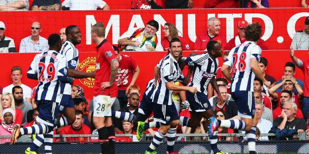 MANCHESTER, ENGLAND - SEPTEMBER 28: Saido Berahino (2nd right) of West Bromwich Albion celebrates with team mates after scoring his sides second goal during the Barclays Premier League match between Manchester United and West Bromwich Albion at Old Trafford on September 28, 2013 in Manchester, England. (Photo by Alex Livesey/Getty Images)