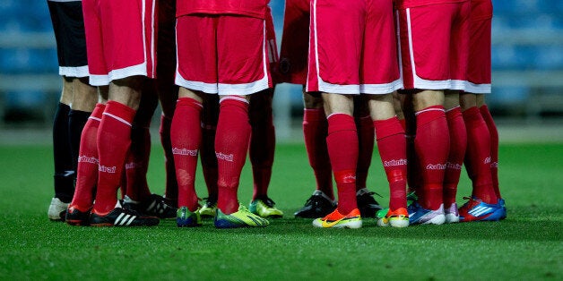 FARO, PORTUGAL - NOVEMBER 19: Captain Roy Chipolina of Gibraltar gives instructions to the team prior to start the international friendly match between Gibraltar and Slovakia at Estadio do Alagarve on November 19, 2013 in Faro, Portugal. (Photo by Gonzalo Arroyo Moreno/Getty Images)