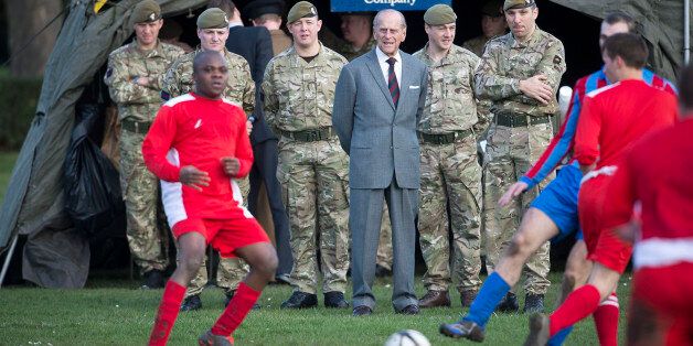 The Duke of Edinburgh (centre) watches a football match during his visit to the First Battalion Grenadier Guards at Lille Barracks in Aldershot, Hampshire.