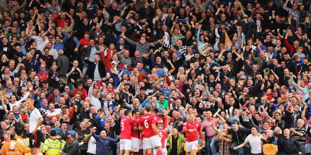 LONDON, ENGLAND - SEPTEMBER 28: Cardiff City fans celebrate Jordon Mutch's winning goal during the Barclays Premier League match between Fulham and Cardiff City at Craven Cottage on September 28, 2013 in London, England. (Photo by Ian Walton/Getty Images)