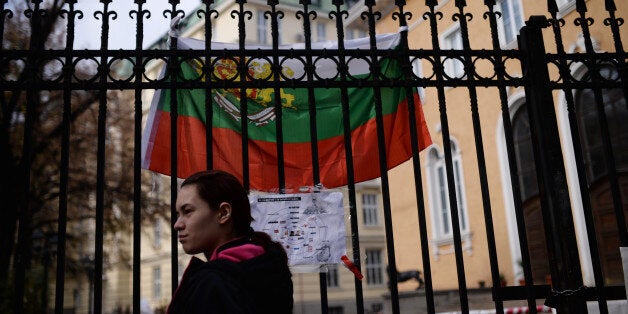 A student stands next a closed entrance of Sofia's university on November 11, 2013. Angry students chained and padlocked the doors to Bulgaria's largest university in Sofia on Monday, demanding the resignation of the embattled Socialist-backed government. The European Union's poorest member state has been rocked by mass anti-government unrest since February, but the demonstrations had subsided in recent months. AFP PHOTO / DIMITAR DILKOFF (Photo credit should read DIMITAR DILKOFF/AFP/Gett