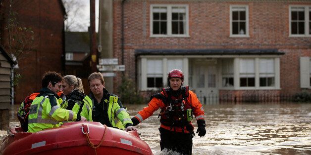 YALDING, UNITED KINGDOM - DECEMBER 25: Emergency services operate along streets submerged beneath floodwaters on December 25, 2013 in Yalding, England. Christmas plans have been badly affected for thousands of people after storms across the UK have resulted in flooding, power cuts and significant problems with transport infrastructure. (Photo by Matthew Lloyd/Getty Images)