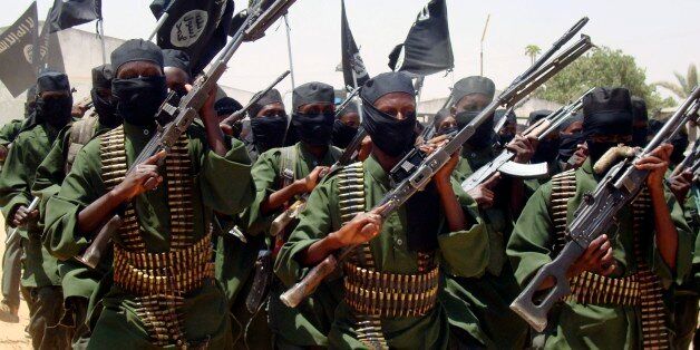 Al-Shabab fighters march with their guns during military exercises on the outskirts of Mogadishu,Somalia