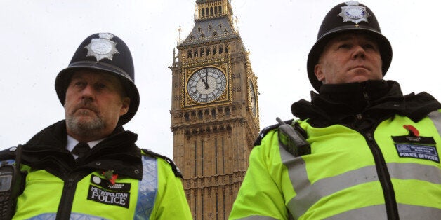 Police officers at the Houses of Parliament observe a two minute silence to commemorate Armistice Day in Parliament Square, London.