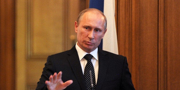 Russian President Vladimir Putin speaks during a press conference inside 10 Downing Street, London.