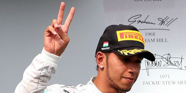 BUDAPEST, HUNGARY - JULY 27: Lewis Hamilton of Great Britain and Mercedes GP celebrates on the podium after claiming third in the Hungarian Formula One Grand Prix at Hungaroring on July 27, 2014 in Budapest, Hungary. (Photo by Mark Thompson/Getty Images)