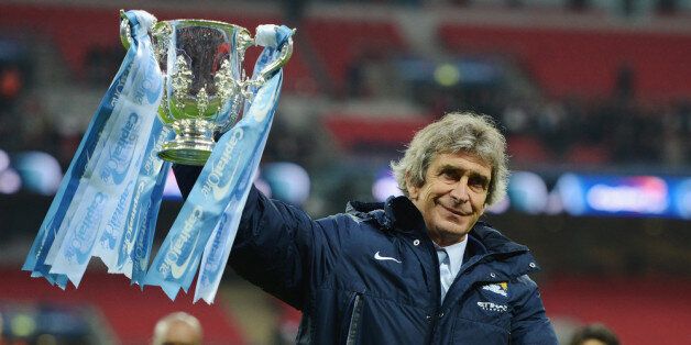 LONDON, ENGLAND - MARCH 02: Manuel Pellegrini, manager of Manchester City celebrates victory with the trophy after the Capital One Cup Final between Manchester City and Sunderland at Wembley Stadium on March 2, 2014 in London, England. (Photo by Michael Regan/Getty Images)