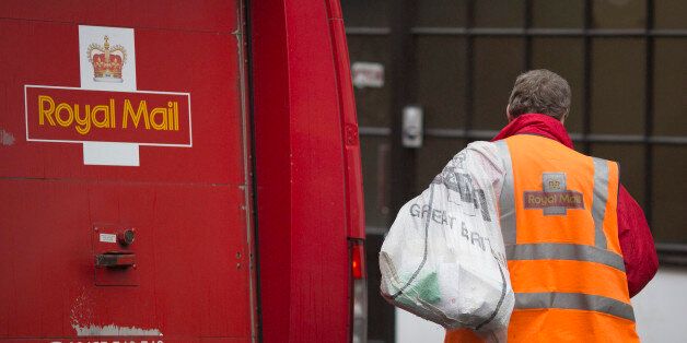 A Royal Mail Group Ltd. employee carries a mail sack towards a postal truck in London, U.K., on Friday, Sept. 13, 2013. Royal Mail Group Ltd., the U.K.'s 360-year-old postal service, intends to hold an initial public offering of a majority stake 'in the coming weeks' to help the company gain a competitive edge against European rivals. Photographer: Simon Dawson/Bloomberg via Getty Images