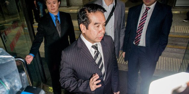 Birmingham City football club owner Carson Yeung walks out of the district court in Hong Kong on November 28, 2012. Former hairdresser-turned-football tycoon Carson Yeung went on trial in Hong Kong on November 28 on money-laundering charges involving tens of millions of dollars, with his lawyers pleading his innocence. AFP PHOTO / Philippe Lopez (Photo credit should read PHILIPPE LOPEZ/AFP/Getty Images)