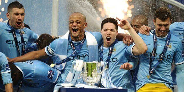 Manchester City's Vincent Kompany (centre) and Samir Nasri (second right) celebrate as they prepare to lift the Capital One Cup trophy following victory over Sunderland