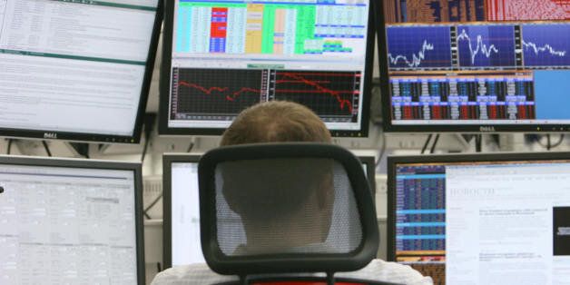A Russian trader studies markets at a private international investment banking firm in Moscow on October 9, 2008. Russia's main stock markets rebounded more than 12 percent, recouping sharp losses suffered the day before as regulators moved to curb volatility by periodically halting trade.The dollar-denominated RTS exchange was up 12.34 percent at 855.61 points when the Federal Service for Financial Markets froze trading at 1005 GMT, the bourse's web site said. The ruble-based MICEX was up 12.53