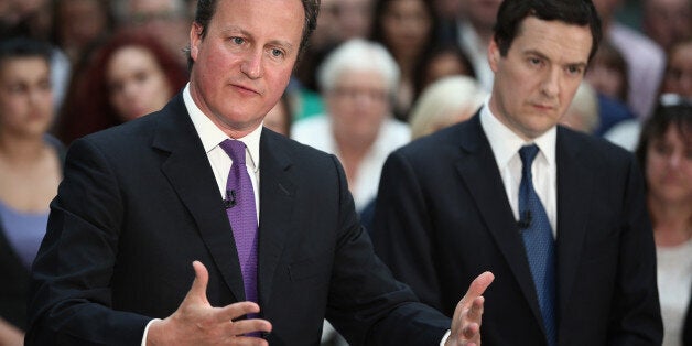 RICKMANSWORTH, ENGLAND - APRIL 22: British Prime Minister David Cameron and British Chancellor George Osborne speak together during a question and answer session at the construction company Skanska on April 22, 2014 in Rickmansworth, England. The Prime Minister and Chancellor who usually avoid joint appearances spoke to employees following the announcement that 200 infrastructure projects are due to be completed in 2014-15, which the government claim will support more than 150,000 construction