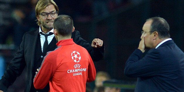 Dortmund's head coach Juergen Klopp (L) argues with an Uefa staff member next to Napoli's Spanish coach Rafael Benitez (R) during the group F Champions League football match SSC Napoli vs Borussia Dortmund on September 18, 2013 at San Paolo stadium in Naples. AFP PHOTO / ALBERTO PIZZOLI (Photo credit should read ALBERTO PIZZOLI/AFP/Getty Images)