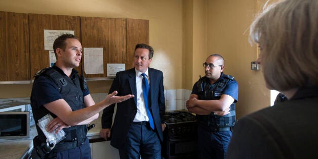 Prime Minster David Cameron (second left) and Home Secretary Theresa May (right) speak to Home Office Immigration Enforcement officers at a property where six immigrants were arrested in Slough, Berkshire.