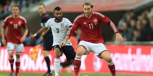 England's Ashley Cole (left) and Denmark's Nicklas Bendtner (right) battle for the ball