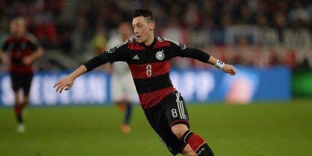 Germany's midfielder Mesut Ozil plays the ball during the International friendly football match Germany vs Chile in Stuttgart, southwestern Germany, on March 5, 2014. Germany won the match 1-0. AFP PHOTO / PATRIK STOLLARZ (Photo credit should read PATRIK STOLLARZ/AFP/Getty Images)