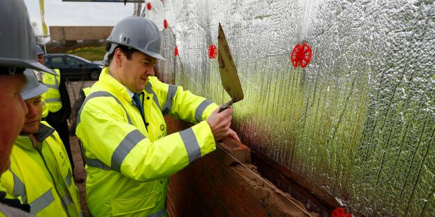 Chancellor of the Exchequer George Osborne lays a brick during a visit to a Barratt Homes building site in Nuneaton, the day after he said in his annual budget that the government would extend the equity loan portion of the Help to Buy scheme for four years longer than planned to 2020, a move he said would deliver 120,000 new homes.