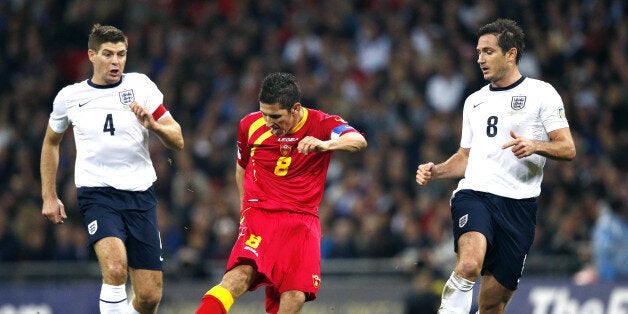 Montenegro's Stevan Jovetic (C) shoots at goal beside England's Frank Lampard (R) and England's Steven Gerrard (L) during the World Cup 2014 Group H Qualifying football match between England and Montenegro at Wembley Stadium in north London on October 11, 2013. AFP PHOTO/ADRIAN DENNIS== NOT FOR MARKETING OR ADVERTISING USE / RESTRICTED TO EDITORIAL USE == (Photo credit should read ADRIAN DENNIS/AFP/Getty Images)