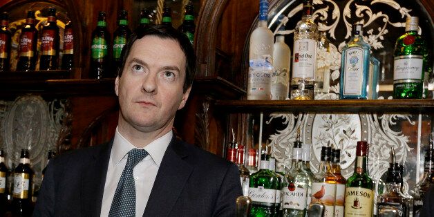 LONDON, ENGLAND - FEBRUARY 25: Britain's Chancellor of the Exchequer George Osborne stands behind the bar during a visit to officially re-open The Red Lion pub following a major refurbishment in Westminster on February 25, 2014 in London, England. (Photo by Kirsty Wigglesworth - WPA Pool/Getty Images)