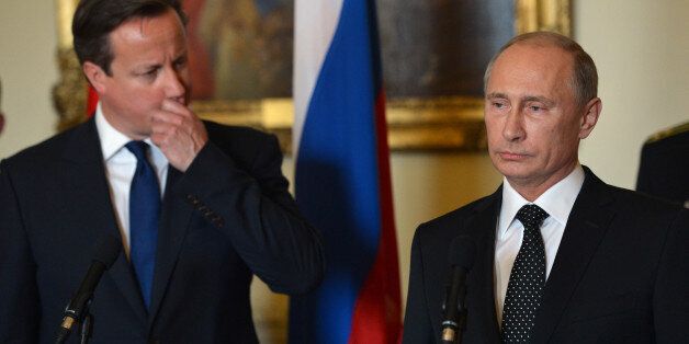 Prime Minister David Cameron and Russian President Vladimir Putin speak as they take part in a ceremony to award the Russian Ushakov medal to Arctic convoy veterans inside 10 Downing Street, London.